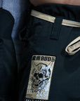 Close-up of a black martial arts gi jacket or shorts with a beige drawstring and a rectangular embroidered patch featuring a skull graphic and the text 'BUD' and 'ON1X VIPER'.